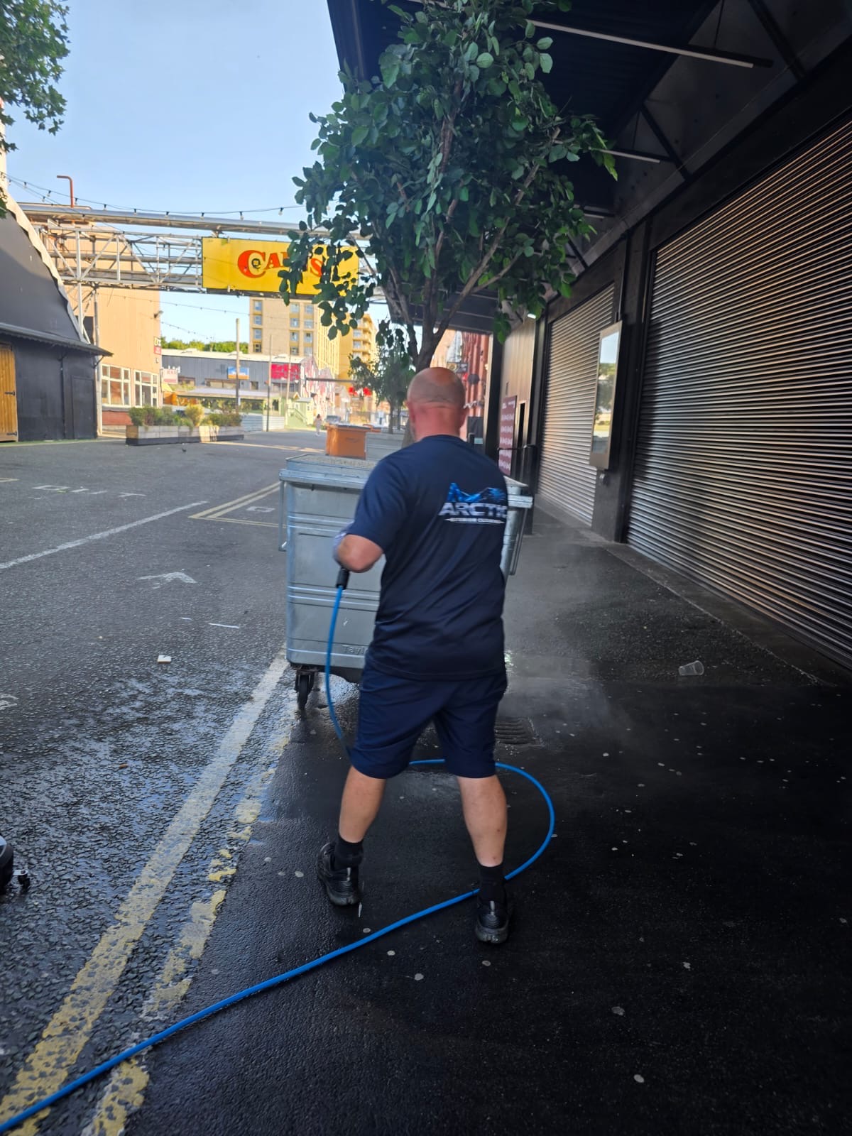 Arctic Exterior Cleaning technician pressure washing a commercial forecourt